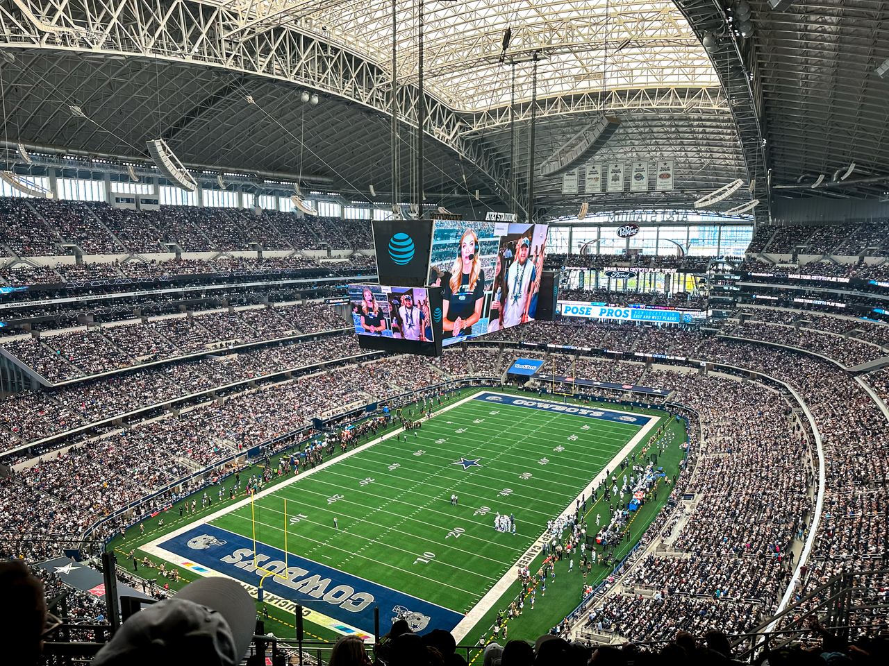 hero-img-02 A packed AT&T Stadium in Arlington, Texas, showcasing a thrilling football game with enthusiastic fans.