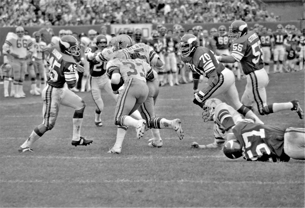about-01 A vintage capture of athletes competing in a high-energy football game.